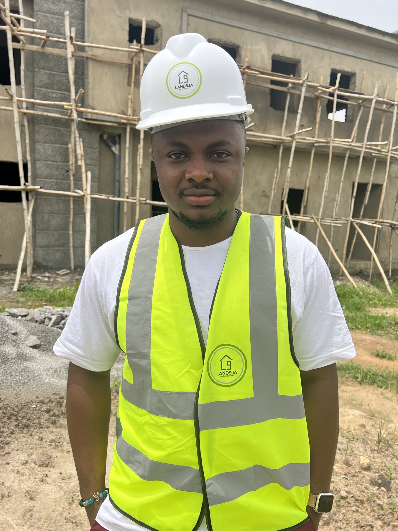Daniel Okechukwu in a Land9ja hard hat and vest at a construction site